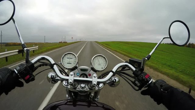 4K. Motorcycle rides on the beautiful road at cloudy day, wide point of view of rider. Classic cruiser/chopper forever!
