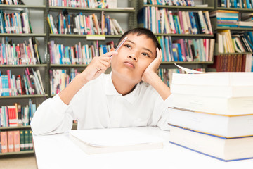 asian boy doing homework .