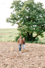 Guy and  girl are alone in the field.