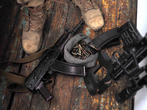 soldier feet and AK rifle on the floor. Sniper rifle.