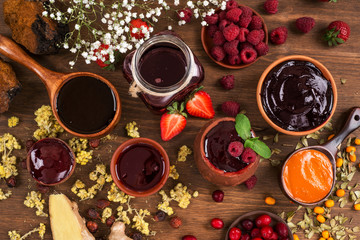 Several types of jam on a wooden table