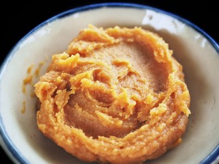 Miso paste on black background