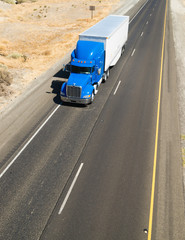 Big Blue Truck Hauling a Load of Freight down the Highway