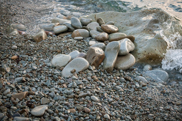Large stones on the beach, washed by the wave