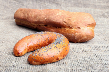 Fresh homemade bread on Sackcloth woven texture background. Selective focus.
