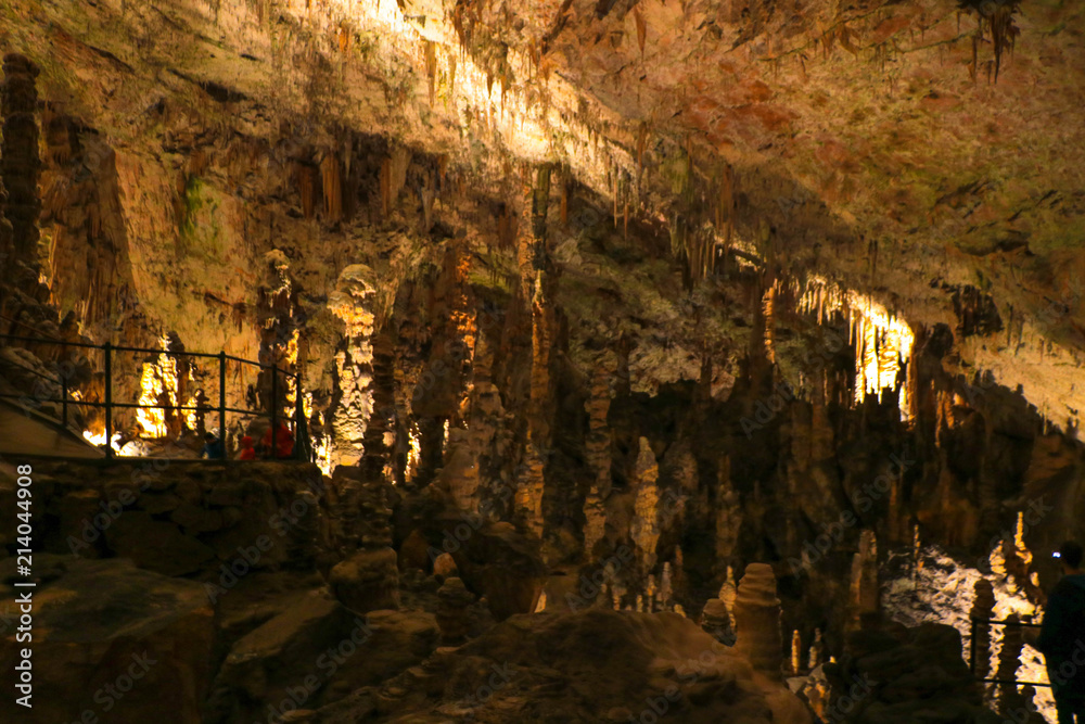 Wall mural postojna cave, slovenia. formations inside cave with stalactites and stalagmites.