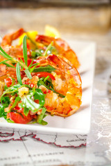 Balkan cuisine. Sea prawns with Mexican salsa on the background of geographical maps, rope and empty bottles. concept sea voyage. Copy space, selective focus