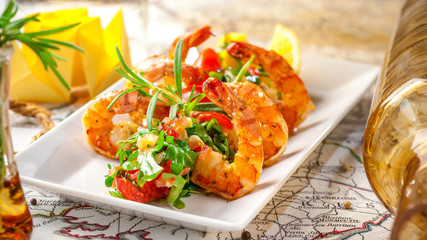 Balkan cuisine. Sea prawns with Mexican salsa on the background of geographical maps, rope and empty bottles. concept sea voyage. Copy space, selective focus