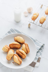 Homemade madeleine on mable background. 