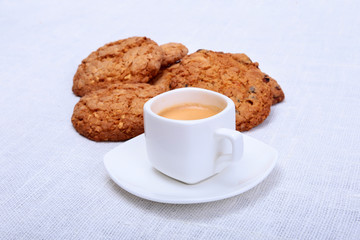 Fresh homemade cake, muffin and cup with espresso on Sackcloth woven texture background. Selective focus.