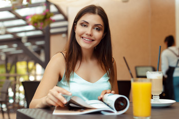 the woman in the cafe sits at a table