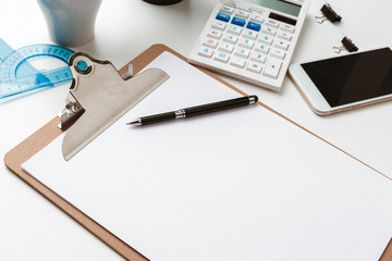 Business Items dropped in creative Disorder on white Table