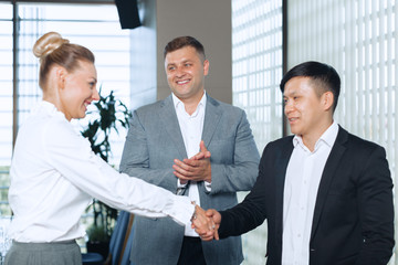 Great job! Two cheerful business people shaking hands
