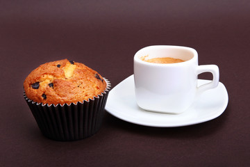 Classic espresso in white cup with homemade cake and chocolate.