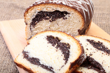 Fresh baked homemade sweet pies, strudel with poppy-seed filling on wooden board.