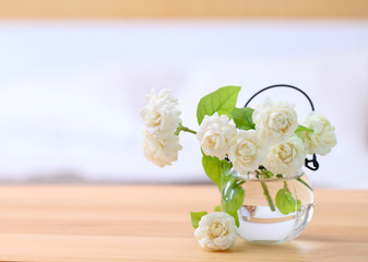 White jasmine flowers in a glass.Beautiful jasmine flower in the pot on the bedroom. .