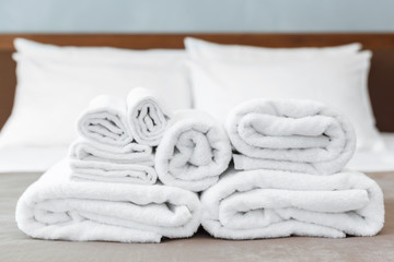 White towel on bed in guest room for hotel customer