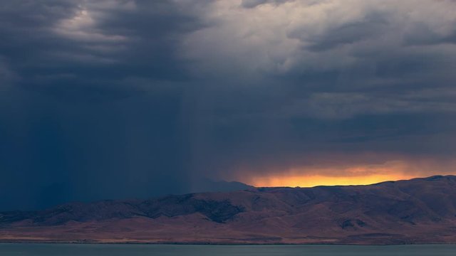 Dark rainstorm rolling across the landscape covering up the horizon at sunset.