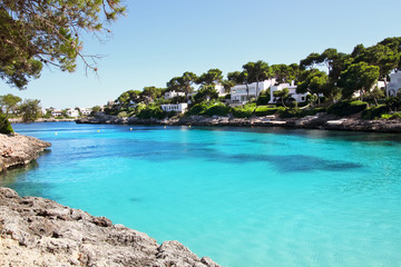 Beautiful Cala d'Or Beach in sunny summer day with turquoise water. Sandy beach Cala Gran in Cala d'Or, Mallorca, Spain.