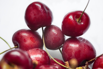 Group of tasty red cherries on white background