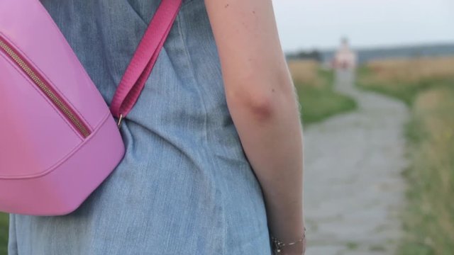 Back view of Young Beautifull Blond Woman travelling to Church of the Intercession on the Nerl. Vladimir region, Russia.