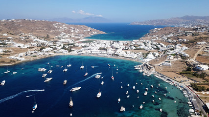 Aerial drone bird's eye view photo of famous organized with sun beds crystal clear water beach of...