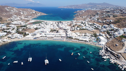 Aerial drone bird's eye view photo of famous organized with sun beds crystal clear water beach of...
