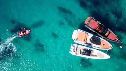 Aerial drone, bird's eye view photo of yachts docked in paradise beach of Psarou with popular pool luxury resorts, Mykonos island, Cyclades, Greece - obrazy, fototapety, plakaty
