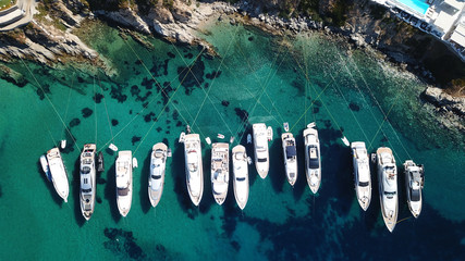 Aerial drone photo of luxury speed boats docked in popular beach of Psarou with iconic resorts,...