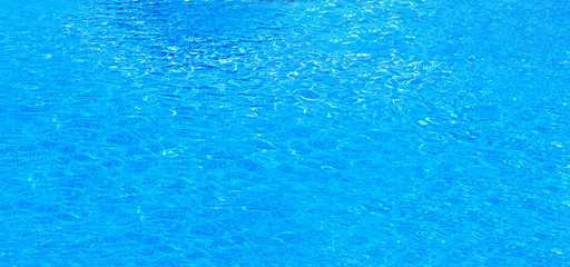 Blue water abstract background, Close up swimming pool rippled texture.