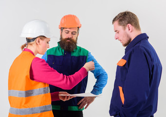 Men in hard hats, uniform and woman.