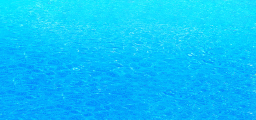 Blue water abstract background, Close up swimming pool rippled texture.