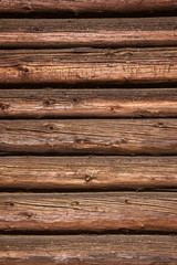 Obraz premium The wooden wall of a village house. Horizontal logs background