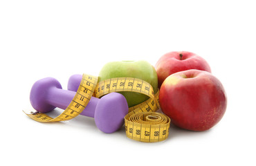 Fresh apples, dumbbells and measuring tape on white background. Diet food
