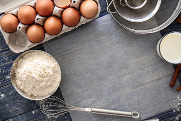 Flat lay composition with kitchen utensils and products on wooden background. Bakery workshop