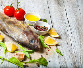 Fototapeta na wymiar Fish and seafood on a wooden, light background, cooking food, a menu for a restaurant or a cafe.