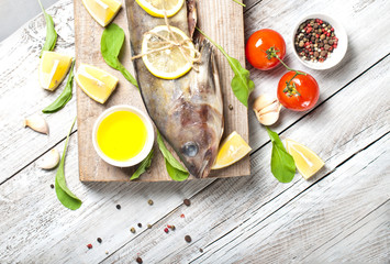 Fish and seafood on a wooden, light background, cooking food, a menu for a restaurant or a cafe.