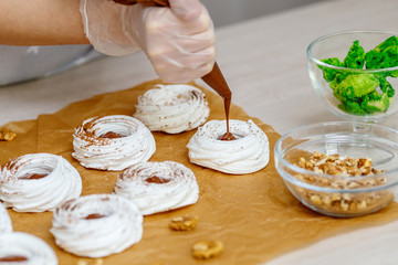 Mini Pavlova meringue nest with eggs, easter sweets, cooking process
