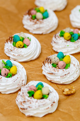 Mini Pavlova meringue nest with eggs, easter sweets