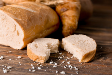 Slice of fresh tasty bread on wooden table