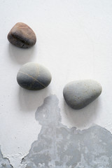 three stones on a white surface. Copy space