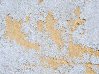 Bright texture of a cracked, old facade, wall. Paint peels off, abstract, grunge