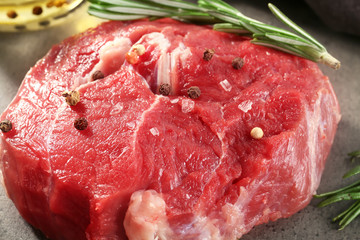 Fresh raw meat with spices on table, closeup