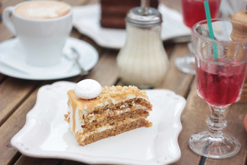The piece of cake on table of summer terrace in cafe, picnic, set table
