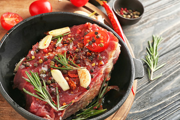 Raw meat with spices on frying pan, closeup