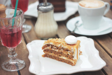 The piece of carrot cake on table of summer terrace in cafe, picnic, set table
