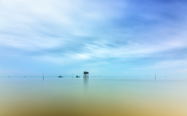Dawn on the beach clam farm in the western coastal region of Vietnam with a small guardhouse before the beauty of nature create idyllic coastal countryside