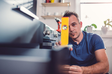 Fototapeta premium Man using leveling tool