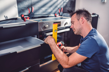 Men building kitchen cabinet