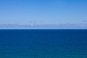 summer background - blue sea and sky with clouds